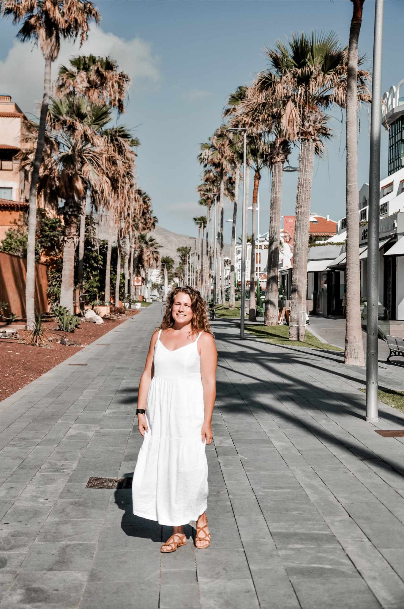 Jessie on a palm-lined promenade