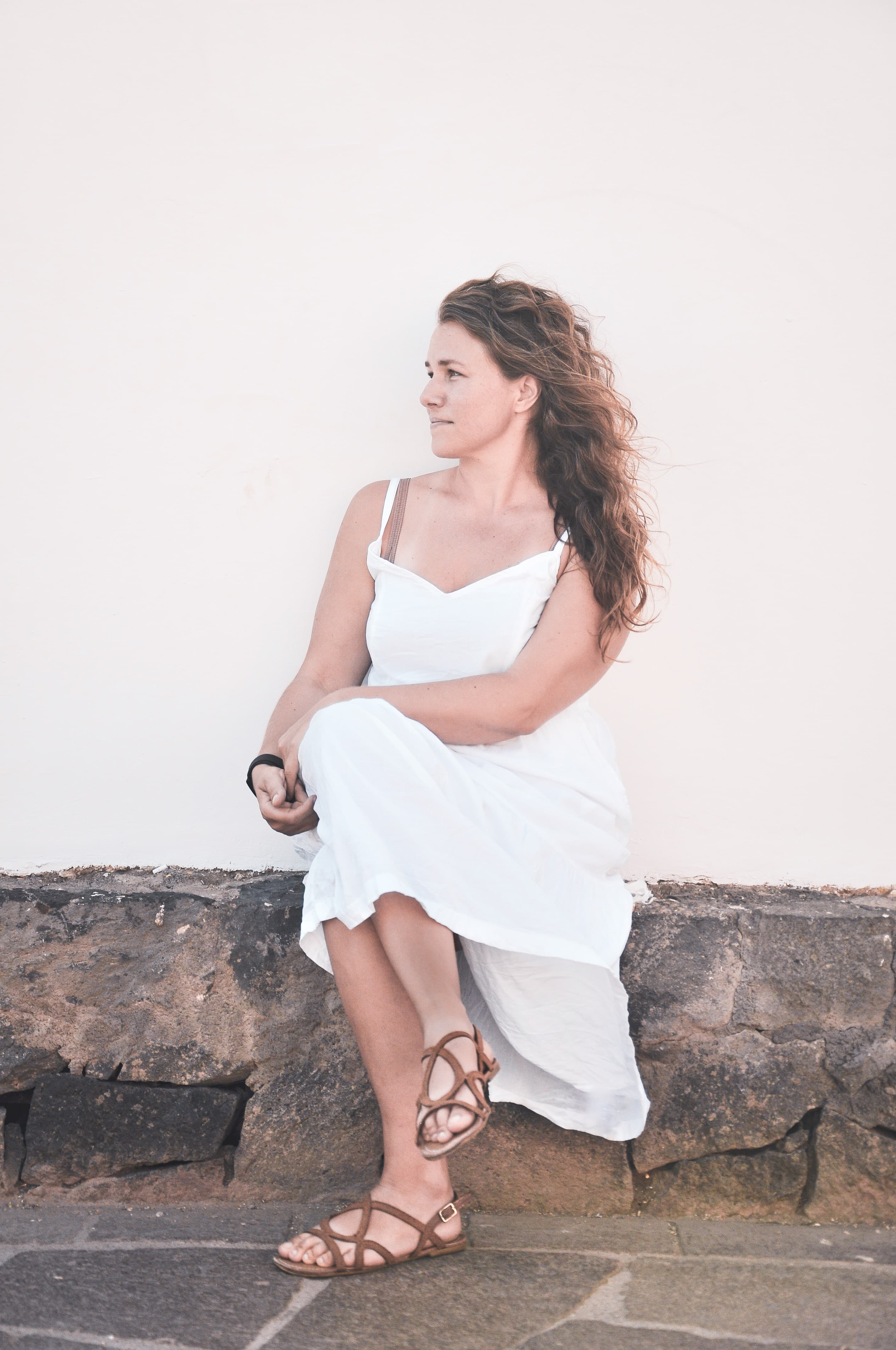 Jessie Faber seated against a sunlit wall